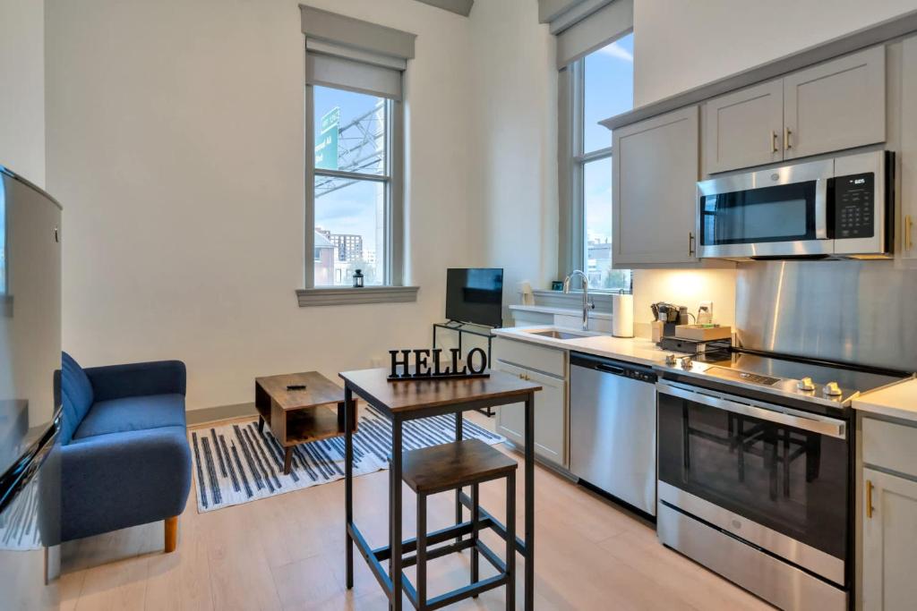 a kitchen with a table and a blue chair at Bright and Modern Studio in Louisville # 301 in Louisville
