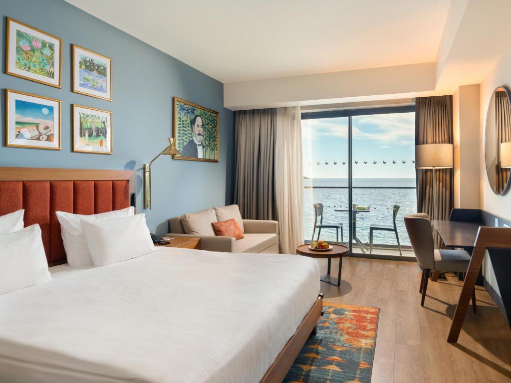 a hotel room with a bed and a desk at Sundia Exclusive By Liberty Fethiye Adults Only in Fethiye