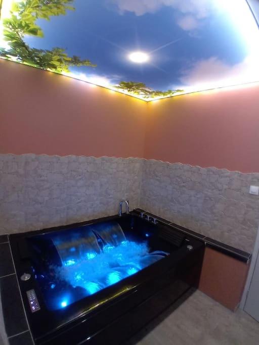 a large jacuzzi tub in a room at Le Rêve Bulle in Abbeville