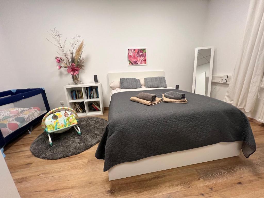 a bedroom with a large bed with a black blanket at Apartment Leipzig Zentrum mit Tiefgarage in Leipzig
