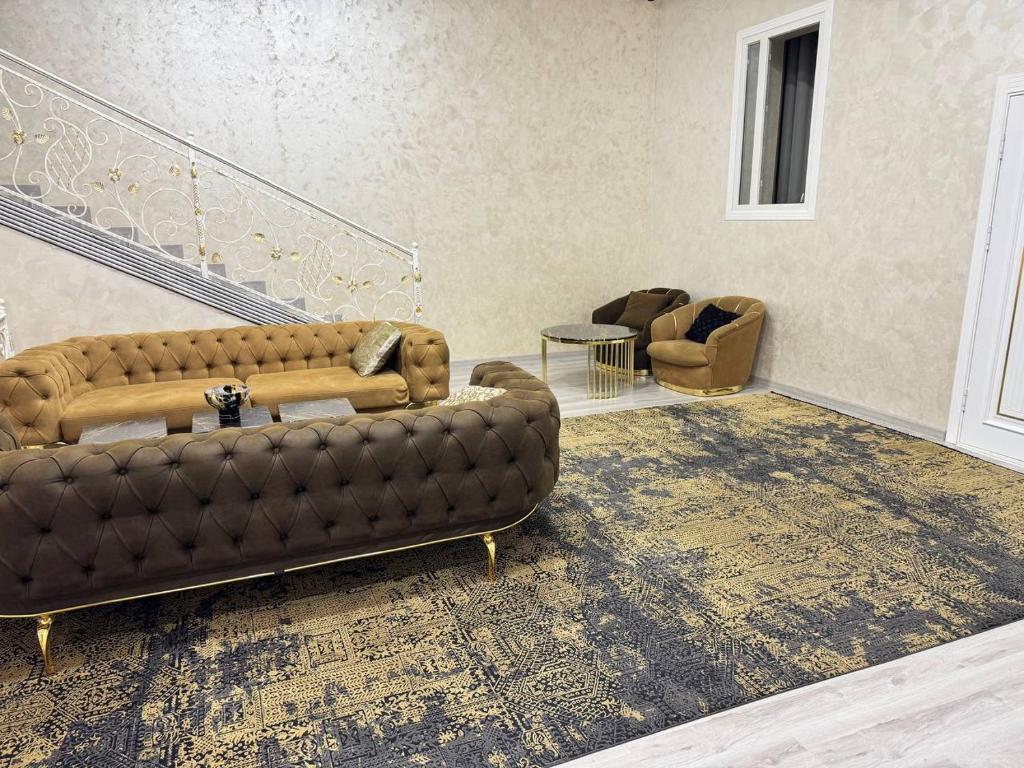 a living room with a brown couch and a table at Sumaya Hotel in Tashkent