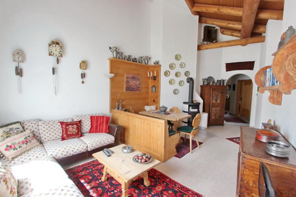 a living room with a couch and a table at Apartment Cign OG in Celerina