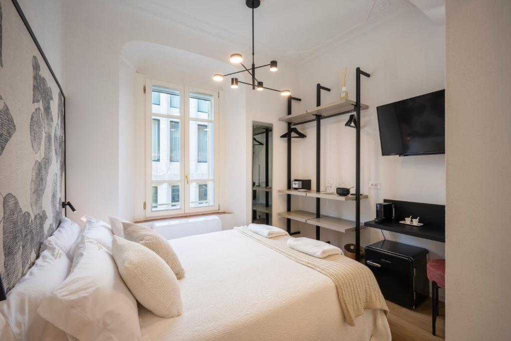 Postel nebo postele na pokoji v ubytování Palazzo Garibaldi Parma Luxury Rooms & Suites