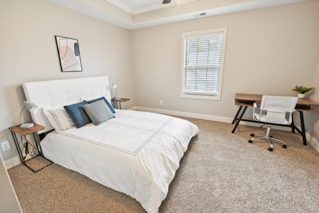 a white bedroom with a bed and a desk and a computer at Biltmore Luxury 1513 #2 Townhomes L 2bd 2 Bth in Clarksville