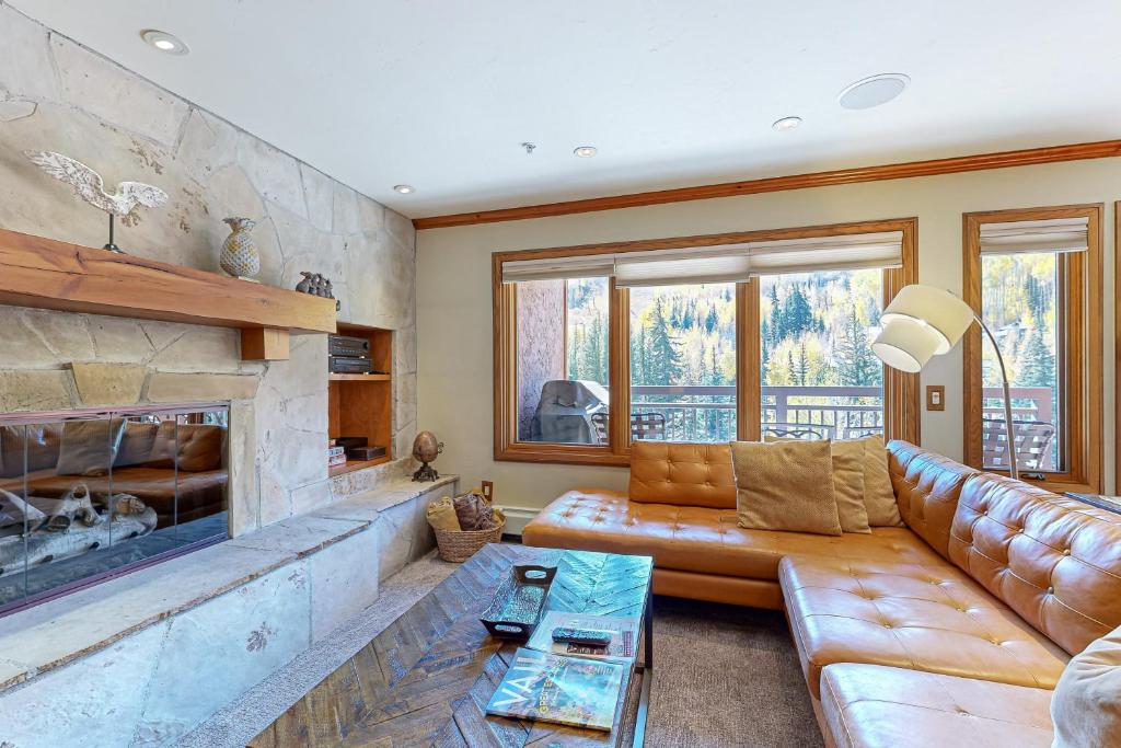 a living room with a couch and a fireplace at Lion Square Lodge South 650 in Vail