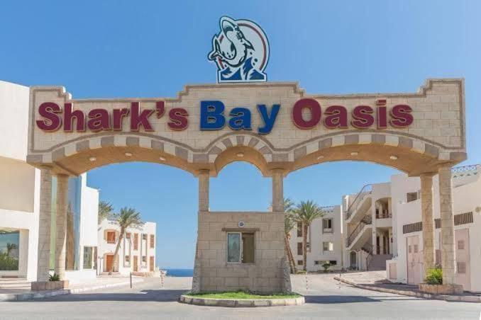 a sign for a sharks bay oasis on a building at sharks bay oasis aqua park in Sharm El Sheikh