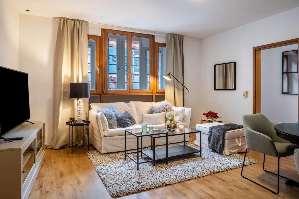 a living room with a couch and a table at Ferienwohnung Gasthaus zum Kranz in Freiburg im Breisgau