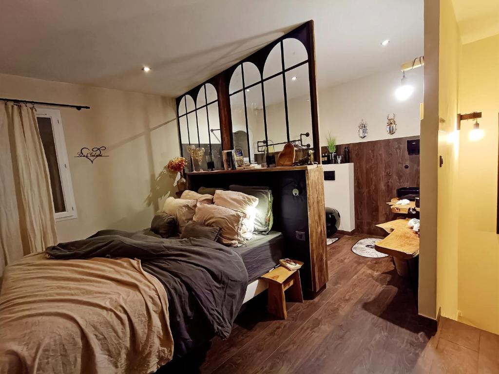 a bedroom with a large bed with a large mirror at Là où le Ciel est né Beau mas pierres et contemporain sur grande propriété vue Mont Ventoux dentelles de Montmirail in Blauvac