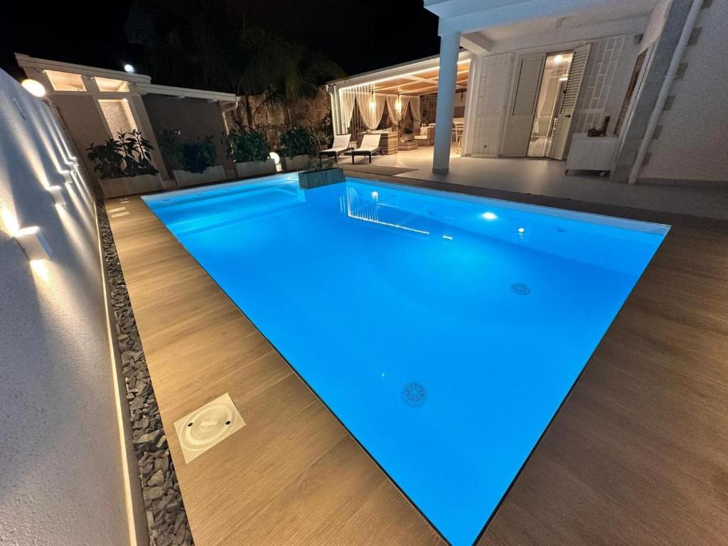 a swimming pool with blue lights on a house at Villa Casa Giò in Santa Maria Del Focallo