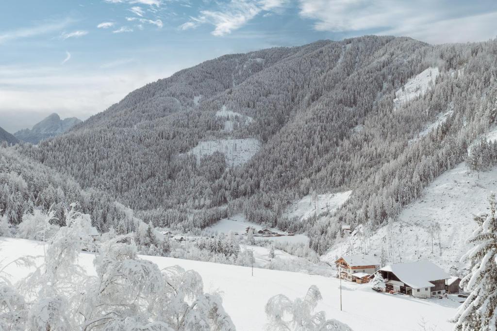 a view of a snow covered mountain with a house at Großkarnaiderhof Appartements-Bauernhof-Natur pur in Luson