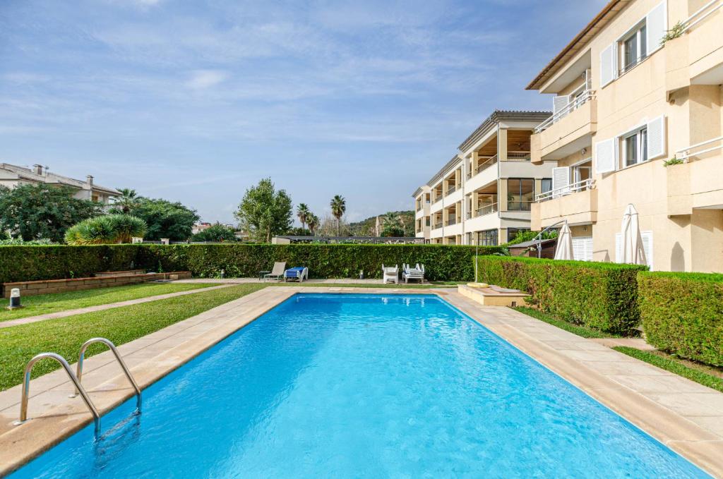 a swimming pool in front of a building at Yourhouse El Xiprer in Pollença