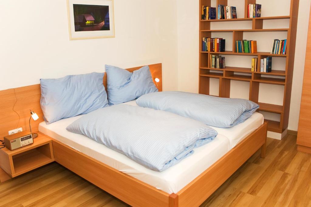 Postel nebo postele na pokoji v ubytování Aparthotel Klopeinersee