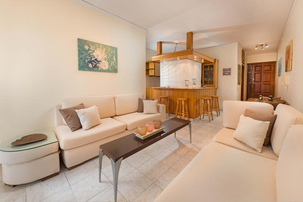 a living room with a couch and a table at Apartment Dream Holidays - 500 meters to beach in Ialyssos