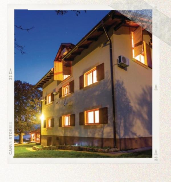a large white building with its lights on at Villa Hills in Janja Gora