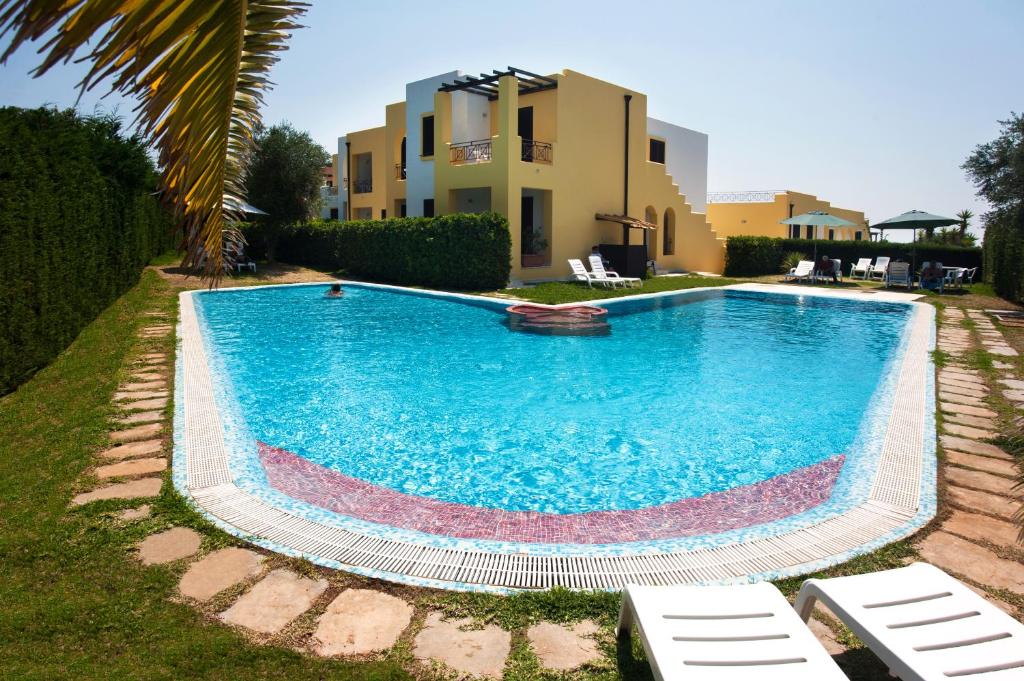 a large swimming pool in front of a building at Oasi D'Oriente in Santa Cesarea Terme