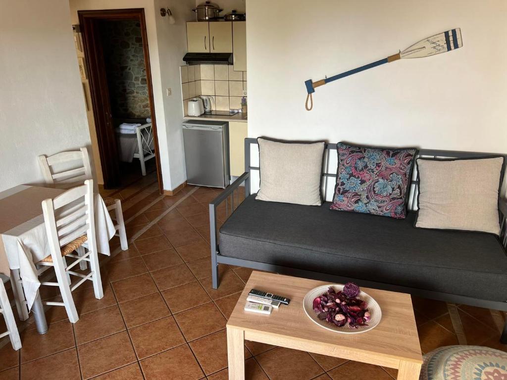 a living room with a couch and a table at Villa Maraki in Agia Paraskevi