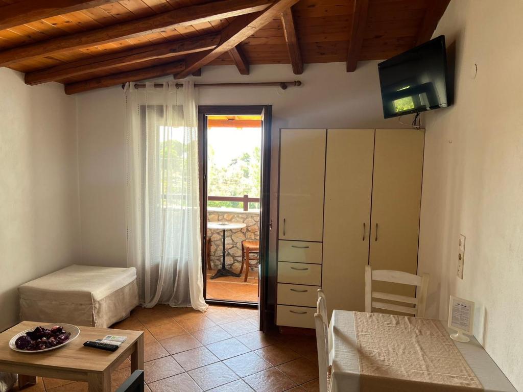 a living room with a bed and a table at Villa Maraki in Agia Paraskevi