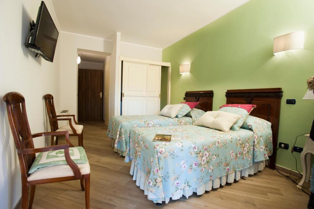 Postel nebo postele na pokoji v ubytování La Vignola Country Hotel