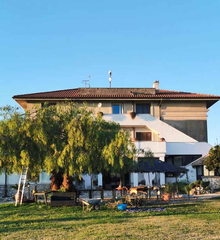 a building with tables and chairs in front of it at Villa Dei Romani - Country House in Guidonia