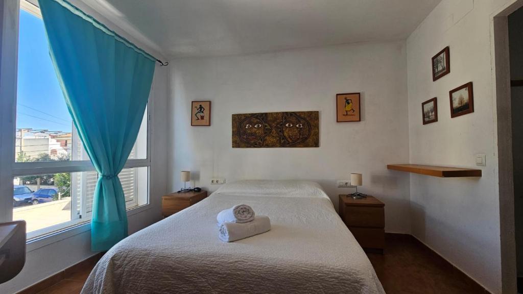 a bedroom with a bed and a large window at El Fortín de la playa by Sanlúcar Housing in Sanlúcar de Barrameda