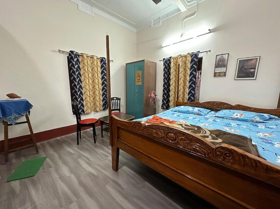 a bedroom with a bed in a room at ATITHI HOMESTAY - Entire 2BHK in Central Bolpur with Private Parking - Pet Friendly in Bolpur