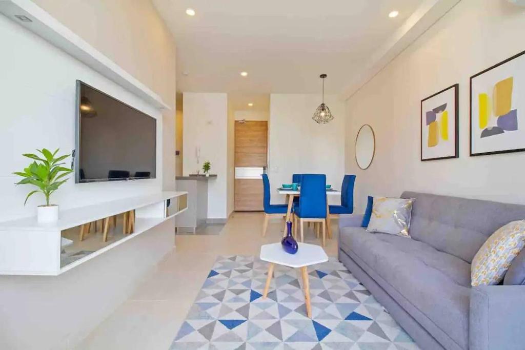 a living room with a couch and a table at Amazing 2BR Apartament with pool in Santa Marta in Santa Marta