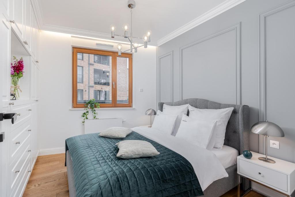 Postel nebo postele na pokoji v ubytování inQse Krakow Brewery Residence