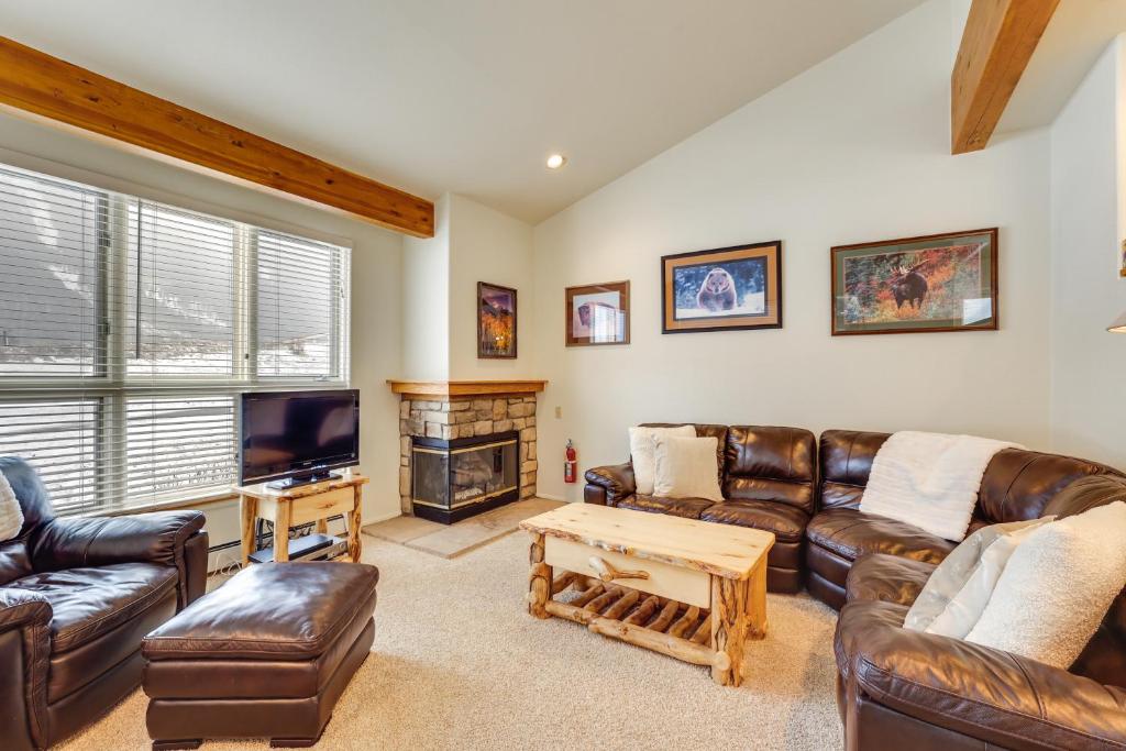 a living room with leather furniture and a tv at Copper Mtn Resort Duplex with Golf Course Views! in Frisco