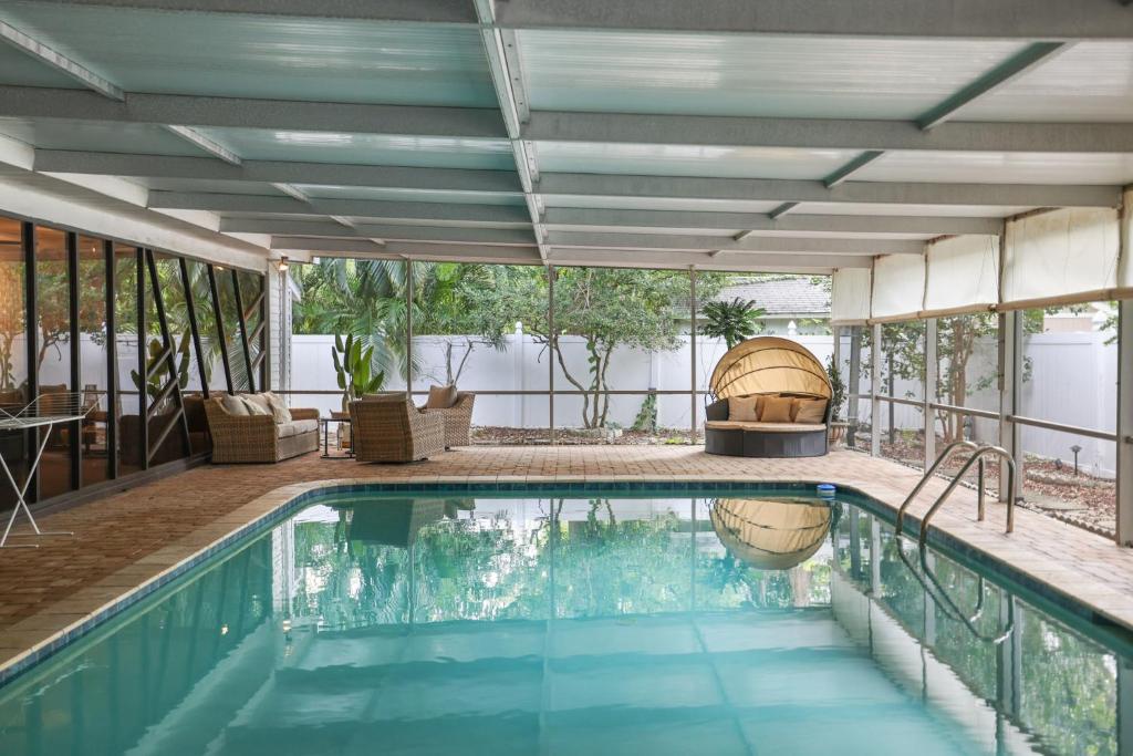 a swimming pool in a house with a patio at Golden Retreat: Expansive 6BR Home w Heated POOL ~ in Seminole