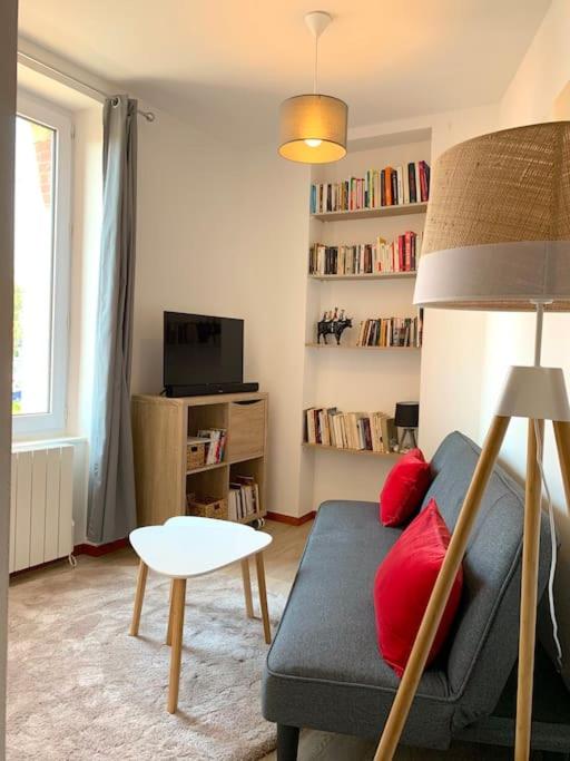 un salon avec un canapé bleu et une table dans l'établissement Maison en triplex au centre-ville de Cherbourg, à Cherbourg en Cotentin