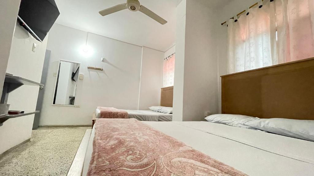Postel nebo postele na pokoji v ubytování Hotel Balcon de Oro Curumani