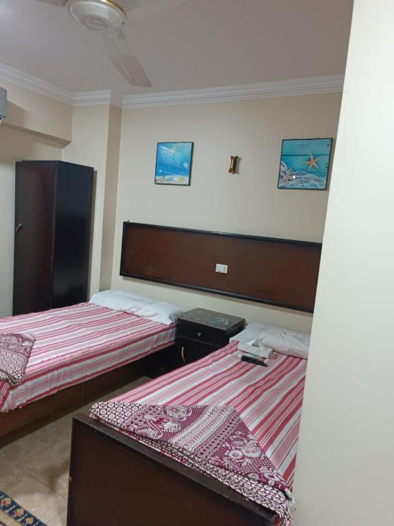 Postel nebo postele na pokoji v ubytování فندق الإيمان El Eman Hotel