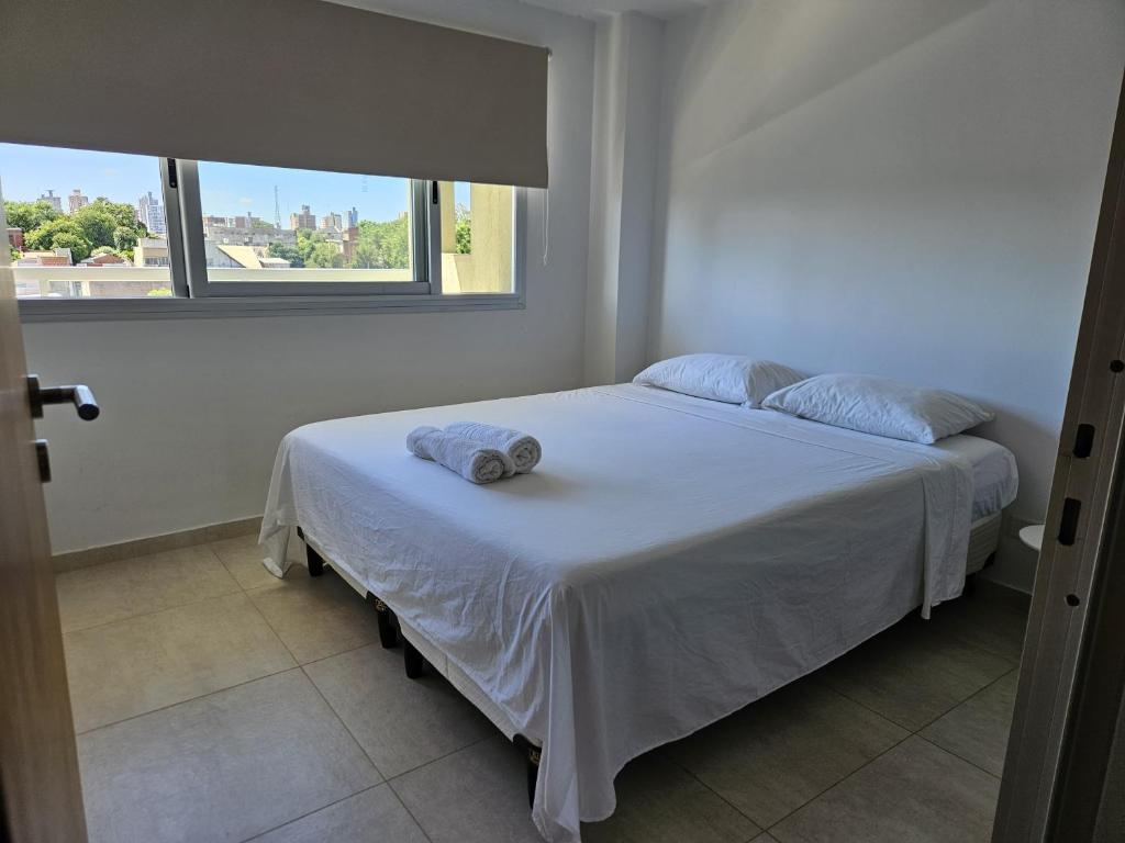 a bedroom with a bed with a towel on it at Departamento de Lujo sobre Costanera in Posadas