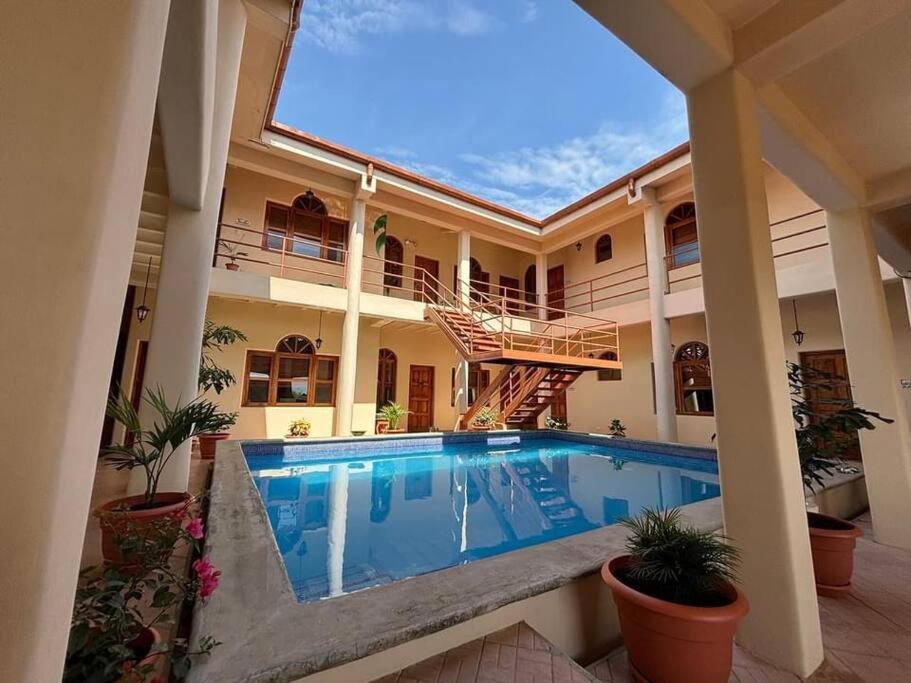 a swimming pool in the middle of a house at St. Francis Suite in San Juan del Sur