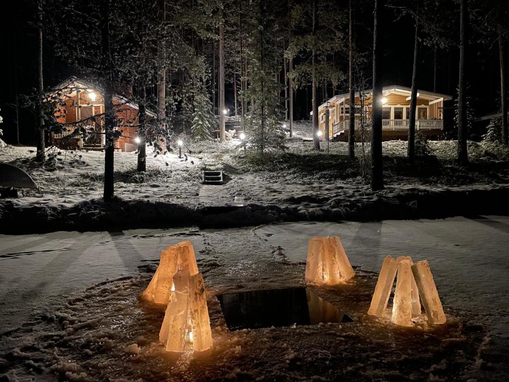 a puddle in the middle of a street at night at Traditional lakeside cottage in Rovaniemi