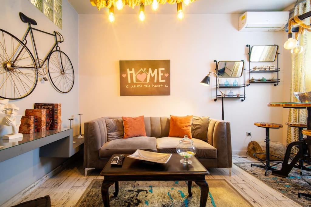 a living room with a couch and a bike on the wall at Diamond apartment in Athens