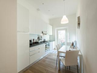 a kitchen with white cabinets and a table and chairs at Casa Maron in Florence