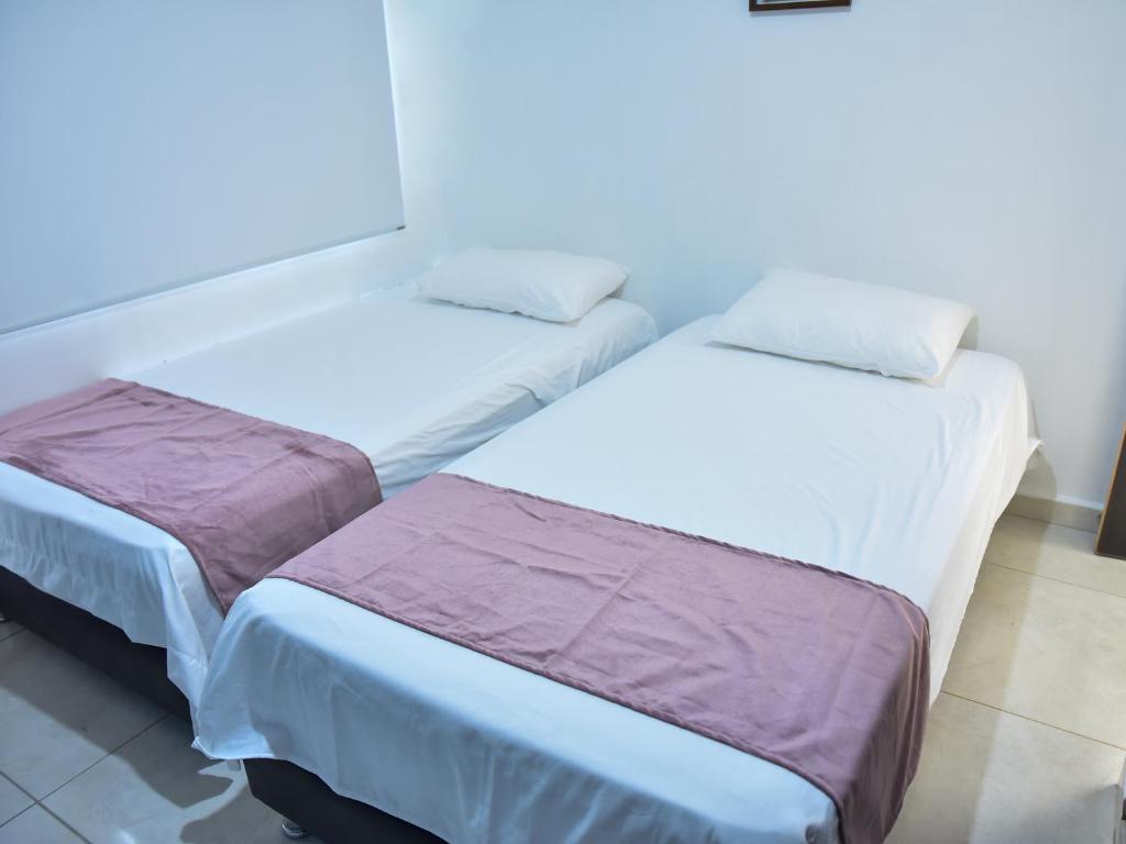Postel nebo postele na pokoji v ubytování Hotel Iguaraya Inn