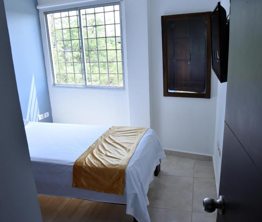 Postel nebo postele na pokoji v ubytování Hotel Iguaraya Inn