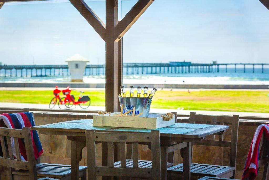 a table on a porch with a view of the beach at OB Pier 1 in San Diego