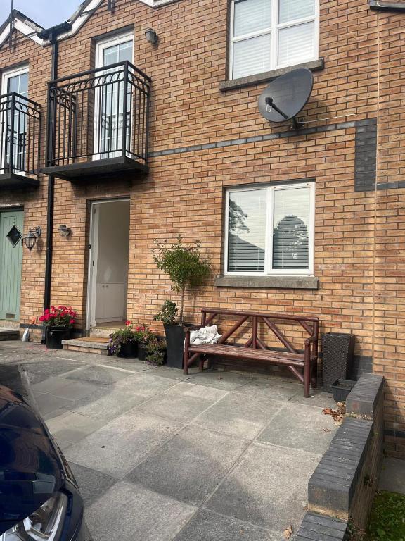 a bench sitting in front of a brick building at Lawnfield Lodge in Newcastle