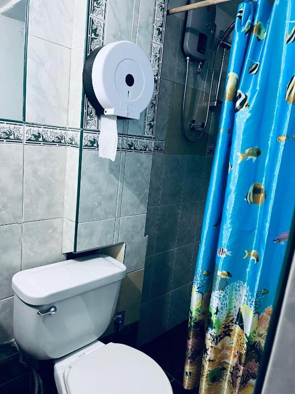 a bathroom with a toilet and a roll of toilet paper at ENEDE HOSTEL in Cusco