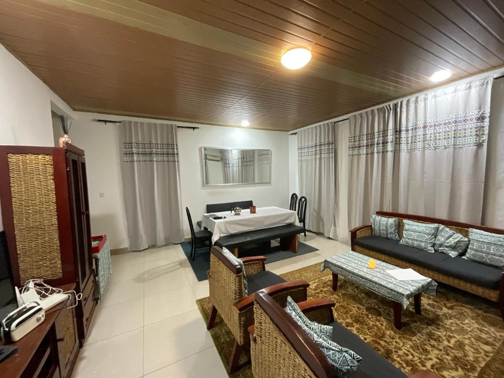 a living room with a couch and a table at Appartement luxueux Ngousso Yaoundé in Yaoundé