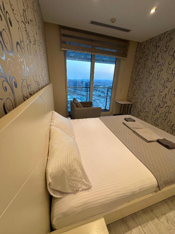 A bed or beds in a room at Ottomare Suites luxury apartment with pool with amazing view