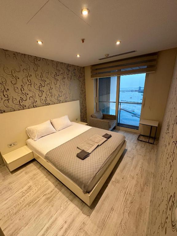 A bed or beds in a room at Ottomare Suites luxury apartment with pool with amazing view