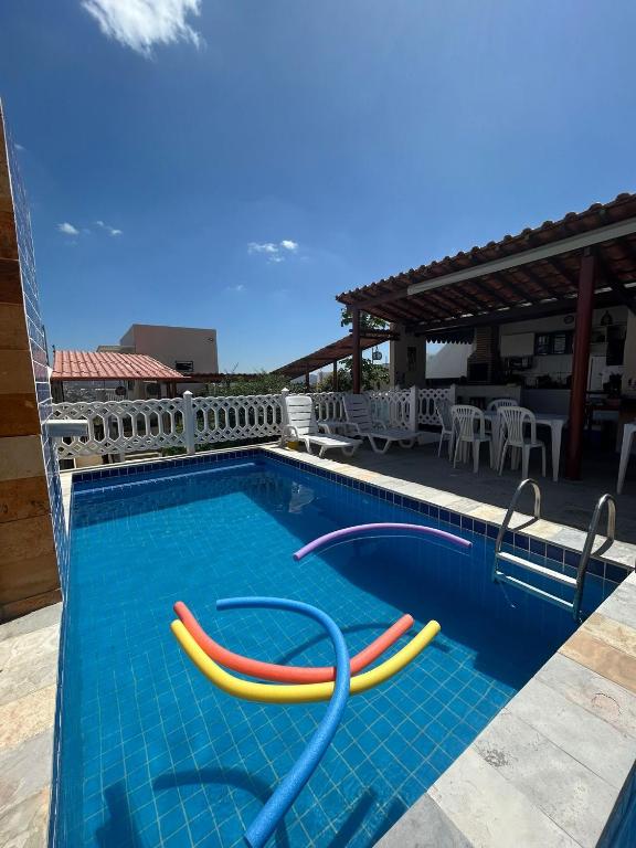 a swimming pool with colorful tubes in the water at Flat Rainha da Serra in Bezerros
