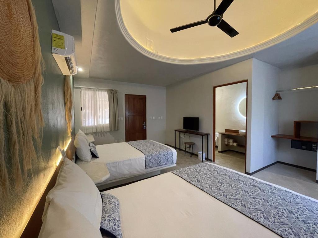 Postel nebo postele na pokoji v ubytování Hotel Circulo Bacalar