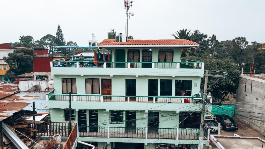 a white building with a balcony on top of it at Hostal Sweet Dreams in Panajachel