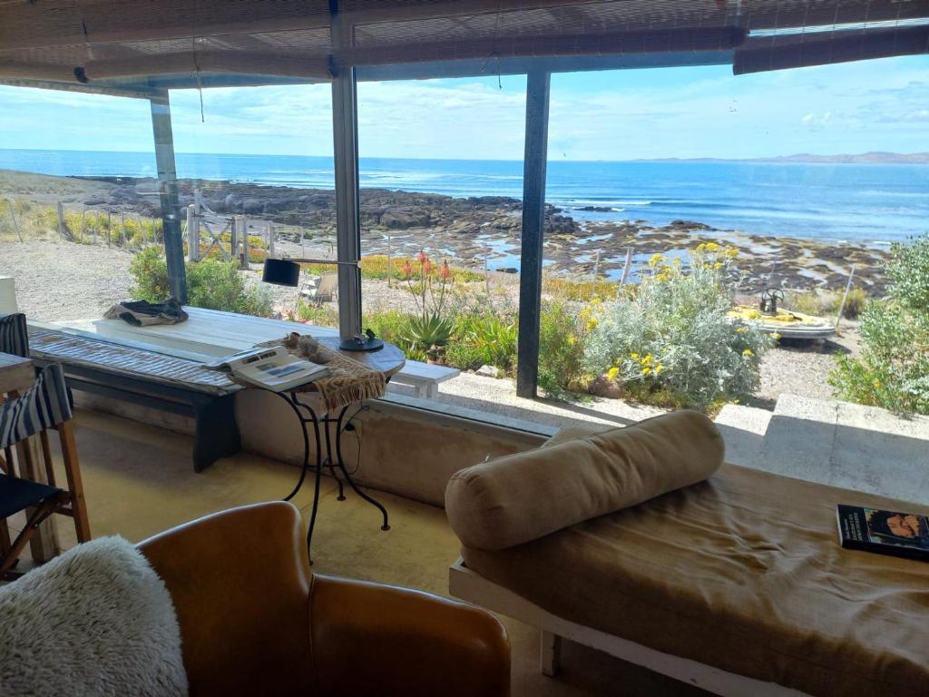 a living room with a couch and a view of the ocean at Casa camarones in Camarones