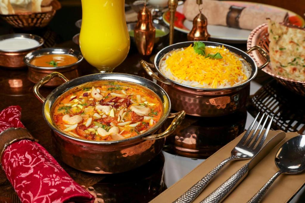 a table with two pots of food on a table at Holiday Inn Kuwait Al Thuraya City by IHG in Kuwait